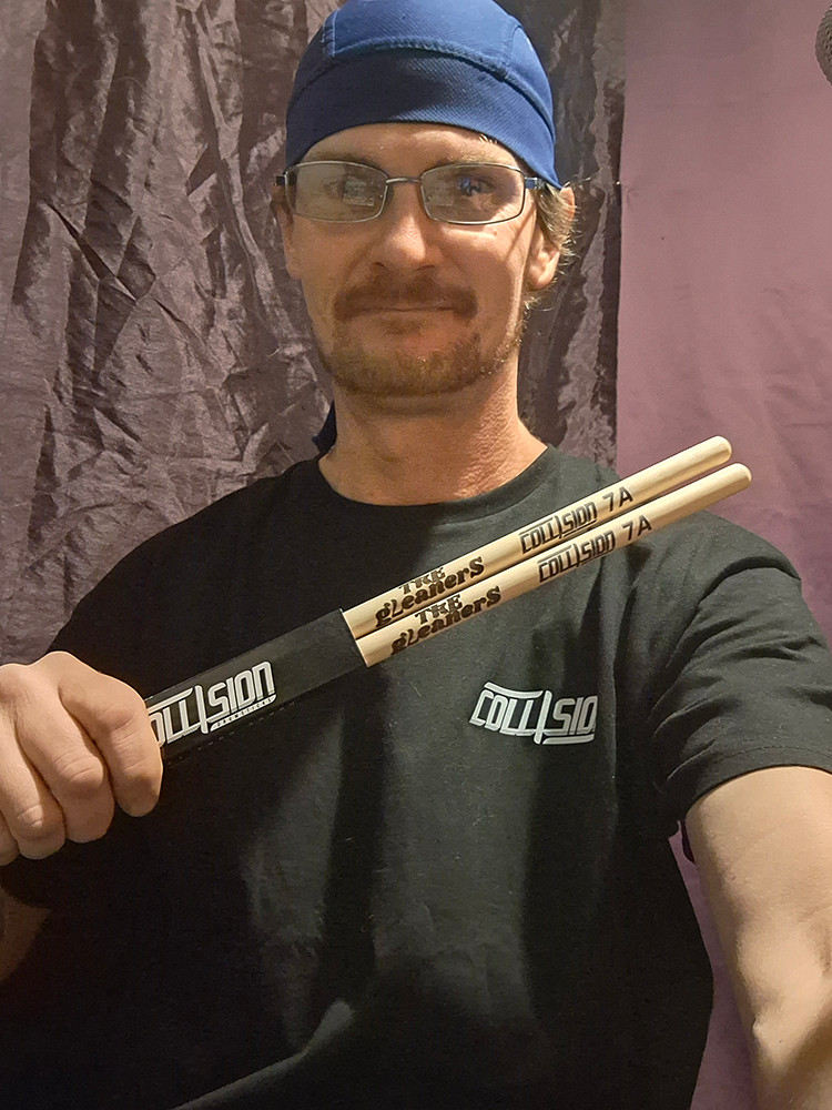 Kevin holding collision drumsticks